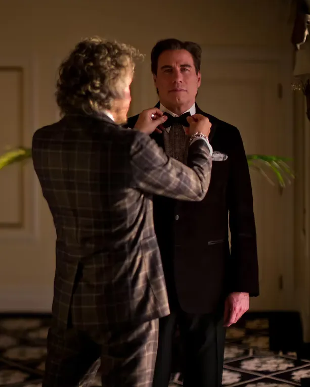 Matteo Perin adjusting John Travolta's bow tie at a private fitting