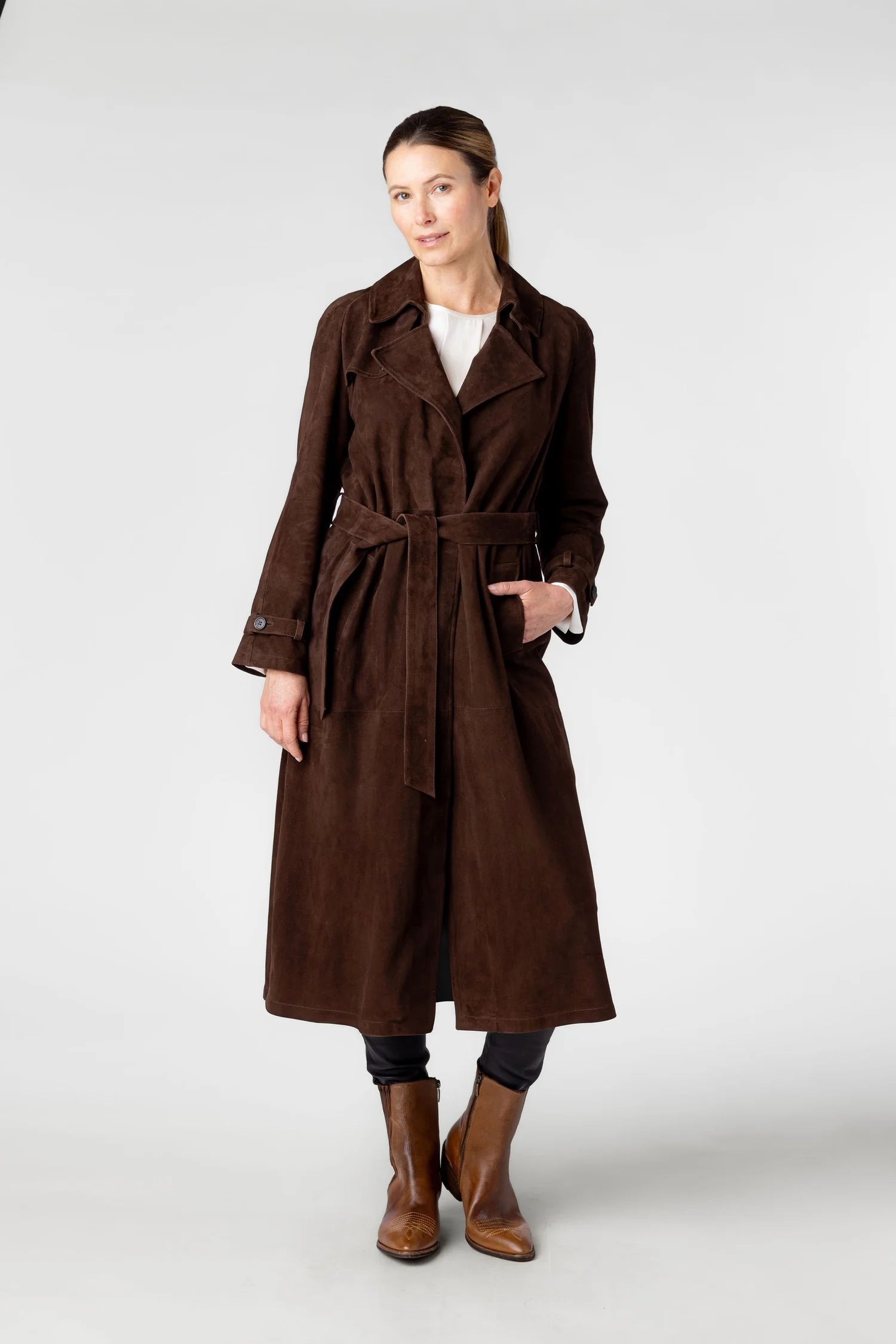 Woman wearing a brown trench coat on a white background