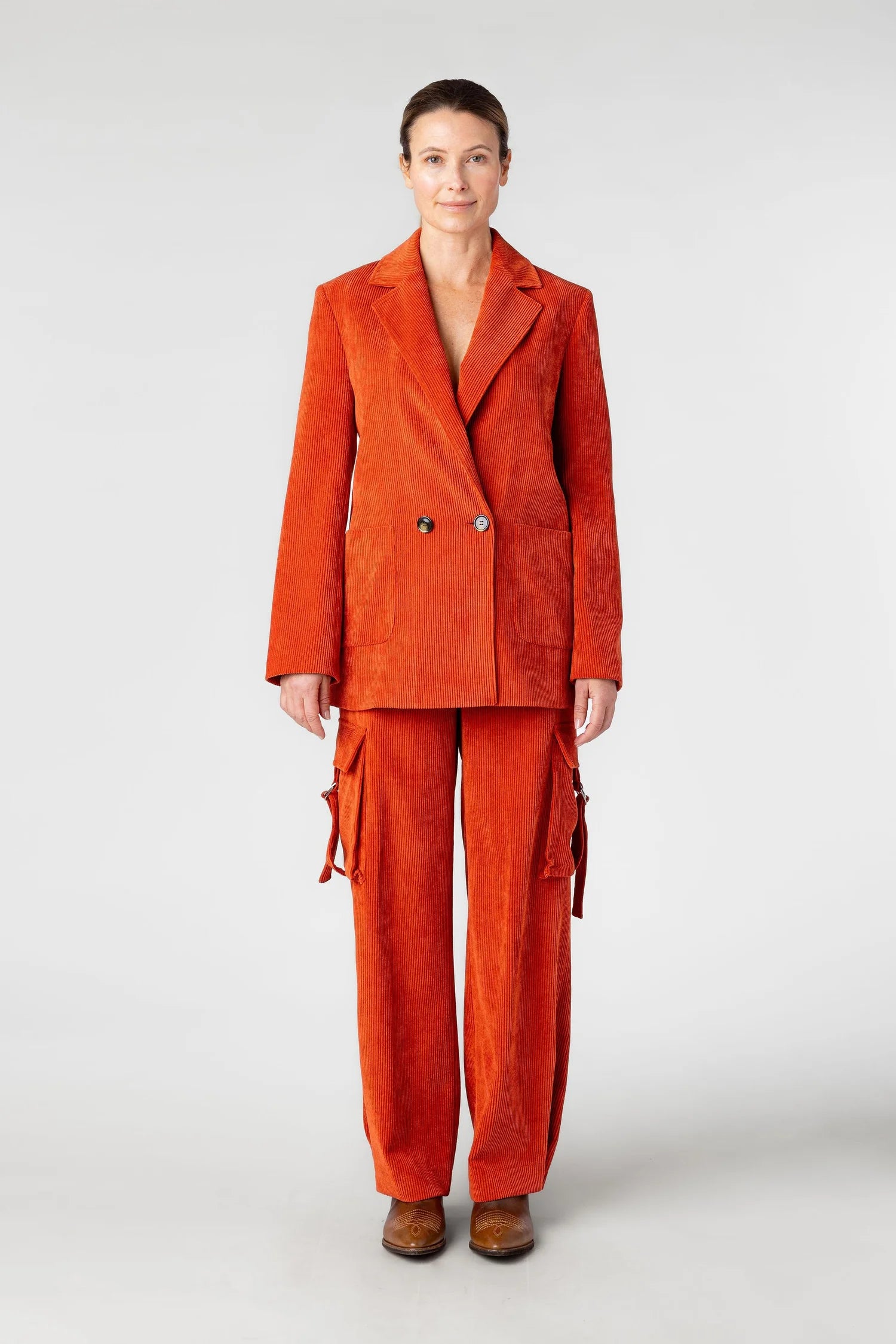 Person wearing an orange suit on a white background