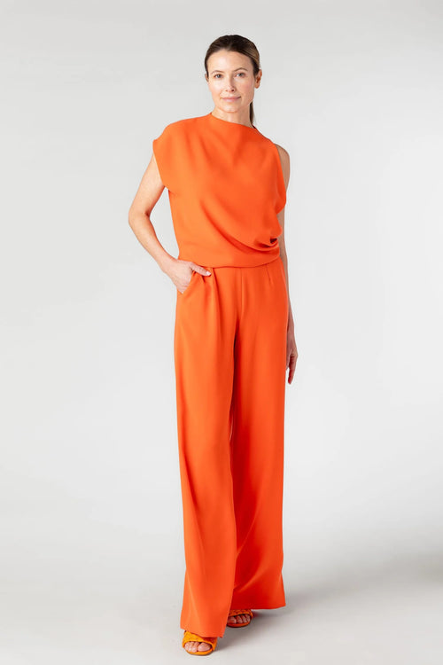 Woman wearing an orange outfit on a white background