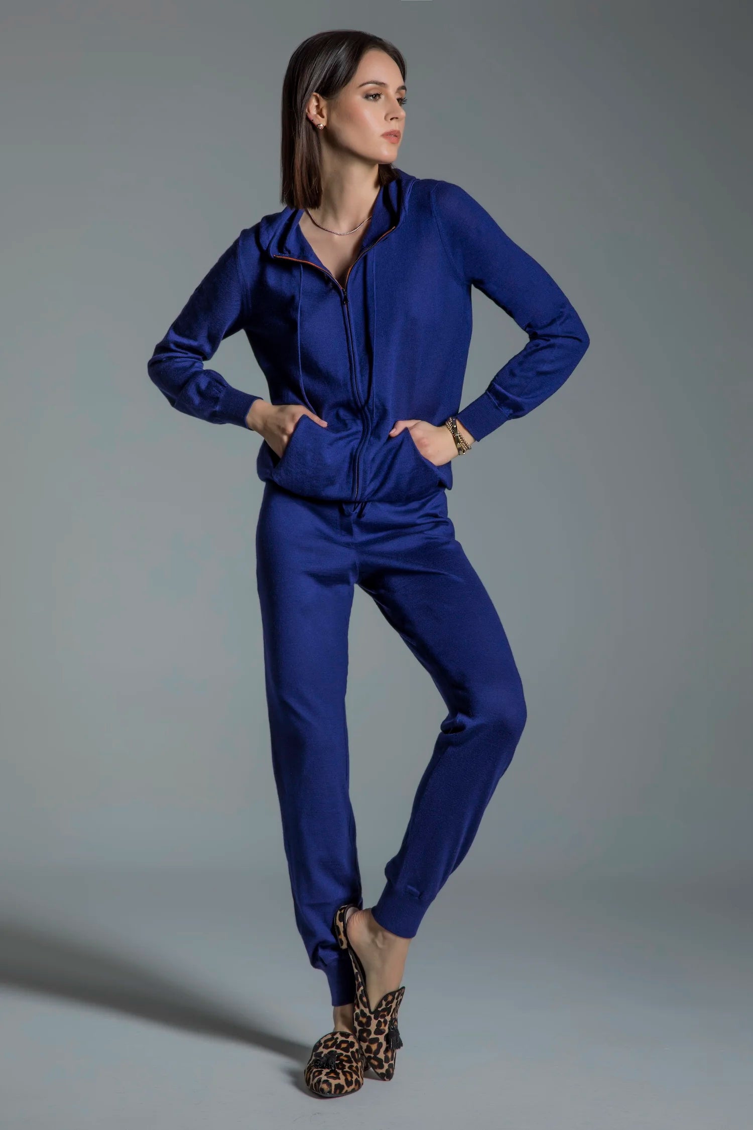 Woman wearing a blue outfit against a gray background