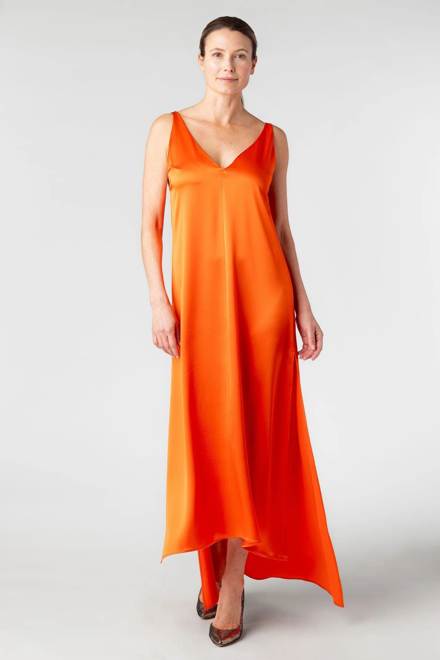 Woman wearing an orange dress on a white background